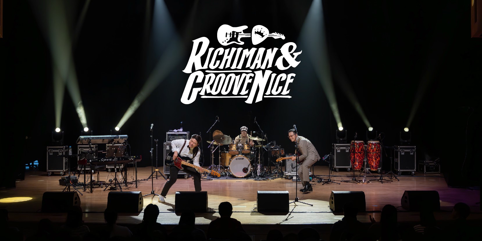 Richiman and Groove Nice logo at teh top, Northeastern America Tour at the bottom over a picture of three men playing instruments on stage, one with a guitar, singing, one with a bass guitar, and behind them, one playing the drums. There is stage lighting.